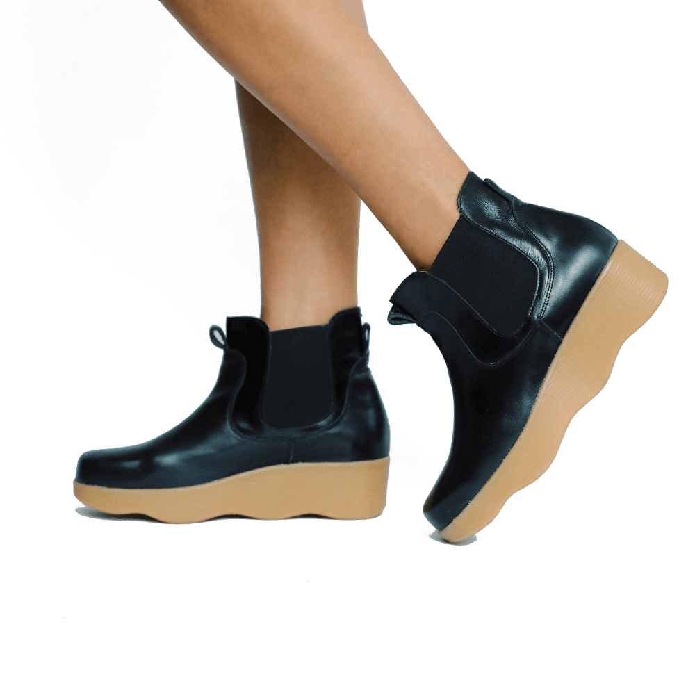 black leather ankle boots with wavy soles