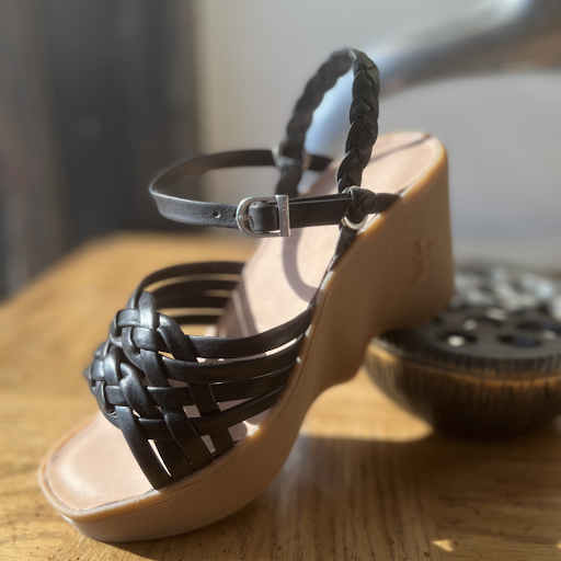 Close-up of Famolare platform slip-on sandals featuring the signature wave sole design.
